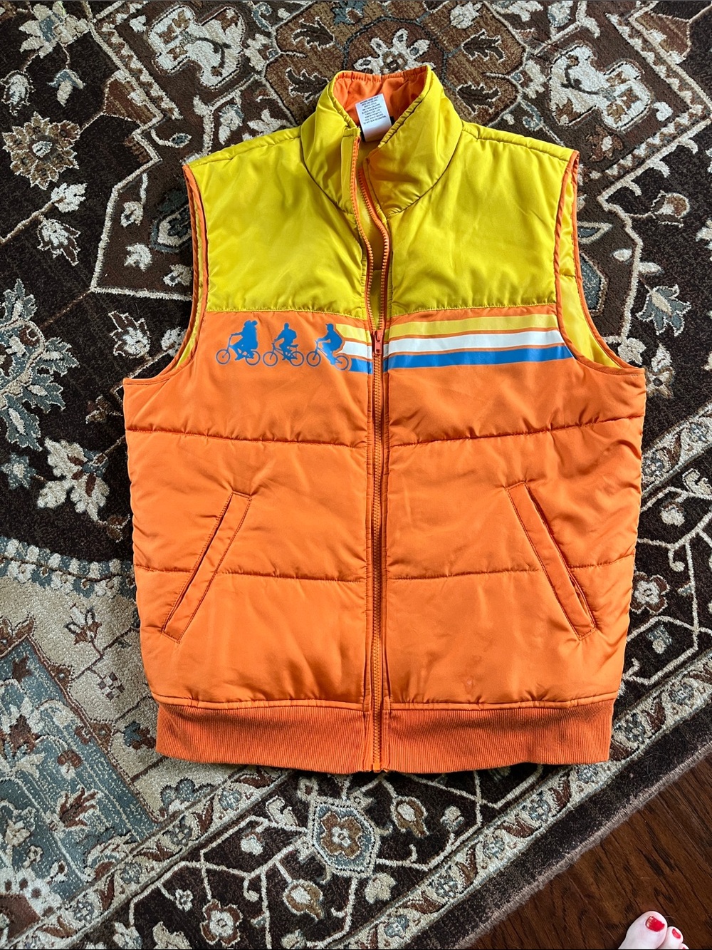 Stranger Things Bright Orange and Yellow Puffer Vest with Bicycle Graphic